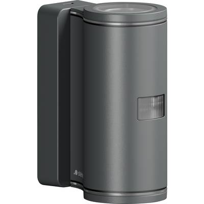 Wall-mounted metallic cylindrical device with a dark side housing and small front indicator window, likely a sensor or dispenser.