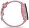 Pink smartwatch with a round face, side buttons, and a silver clasp, shown in profile on a white background.<br>