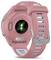 Back view of a pink Garmin Forerunner 265S smartwatch with a silicone band, showing heart-rate sensor lights and buckle.
