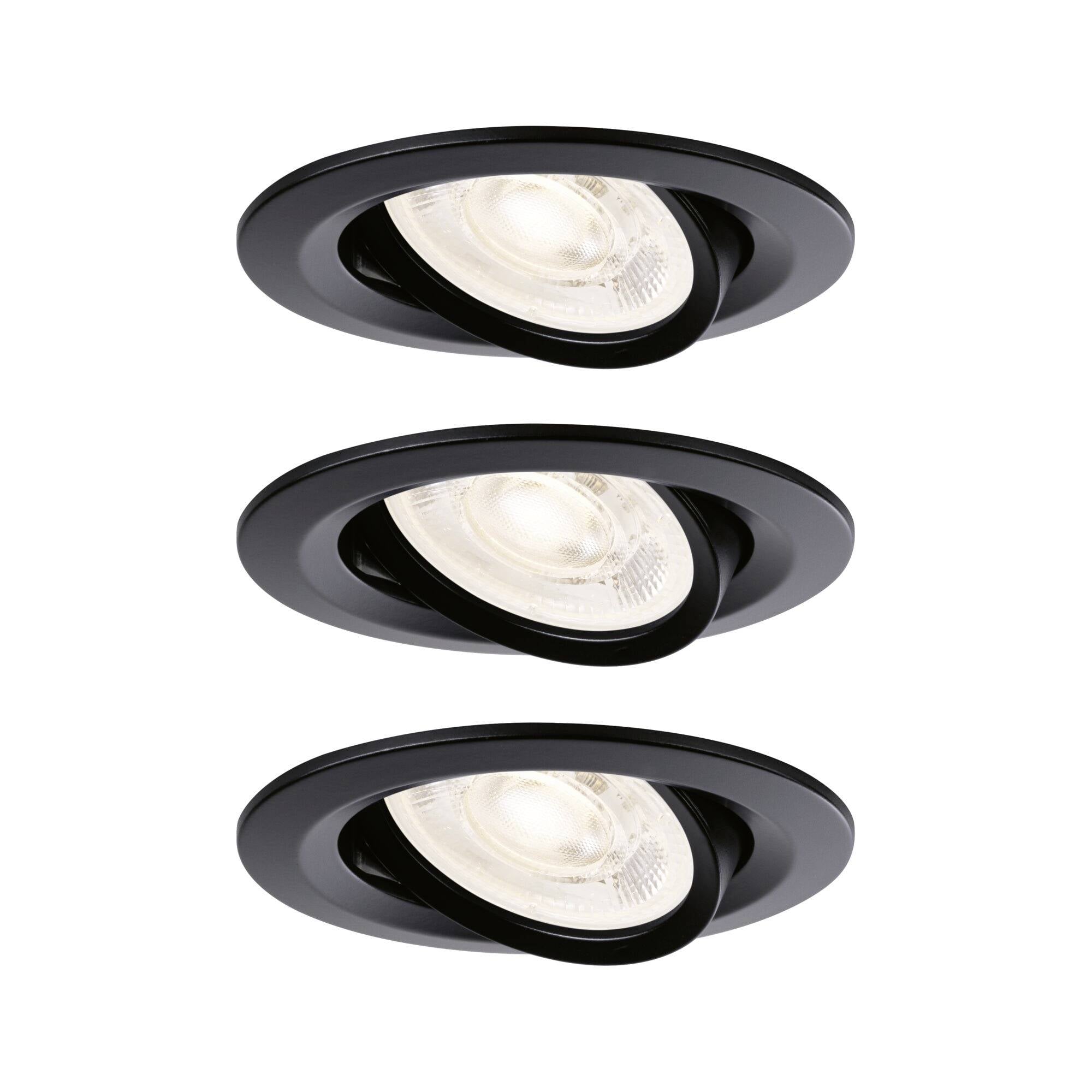Three black recessed ceiling spotlights, each tilted with a lit bulb on a white background.
