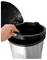 Hand placing a trash bag into an open stainless steel step trash can with lid raised.<br>