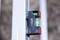 Close-up of a spirit level attached to a metal post, showing the bubble centered for alignment.<br>