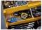 Open toolbox drawer with assorted hand tools, including hex keys, screwdrivers, wrenches, bolts, nuts, and a headlamp.
