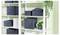 White shelving unit with several dark fabric storage bins, books, and potted trailing plants in a bright room.<br>