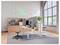 Modern office workspace with standing desk, dual monitors, stool, shelving, and neon 'FEEL GOOD' sign by large arched window.