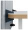 Close-up of a desk clamp mounted to a wall, securing a layered tabletop or shelf with a visible tightening screw.