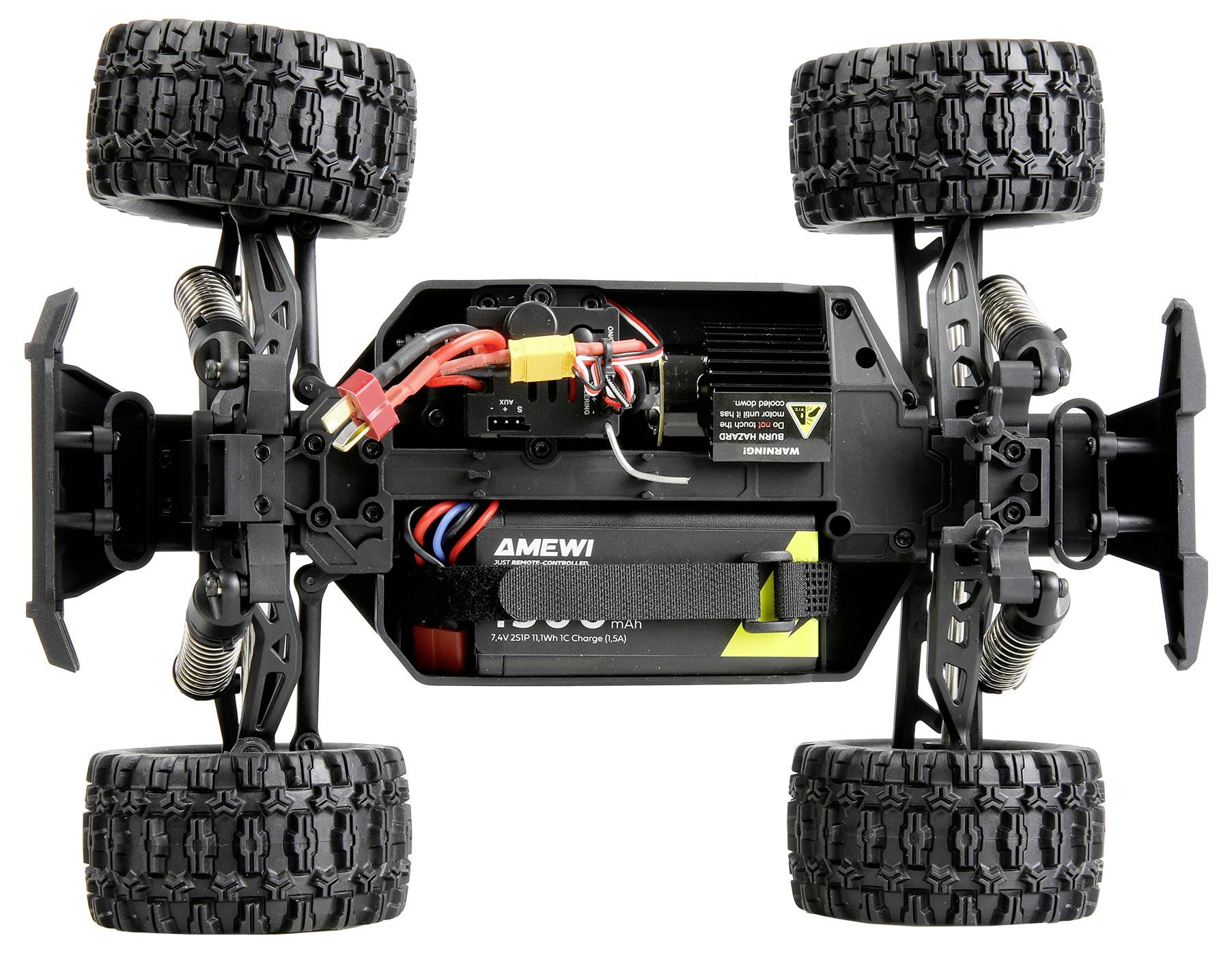 Bottom view of an RC truck chassis showing four rugged tires, suspension, battery pack, wiring, and drivetrain components on a white background.