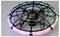 A small black flying drone encased in a circular protective cage, with glowing pink and green LED lights around the rim.