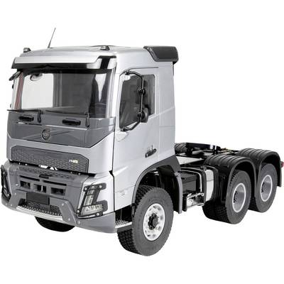Silver three-axle semi-truck cab viewed from the front-left on a white background.