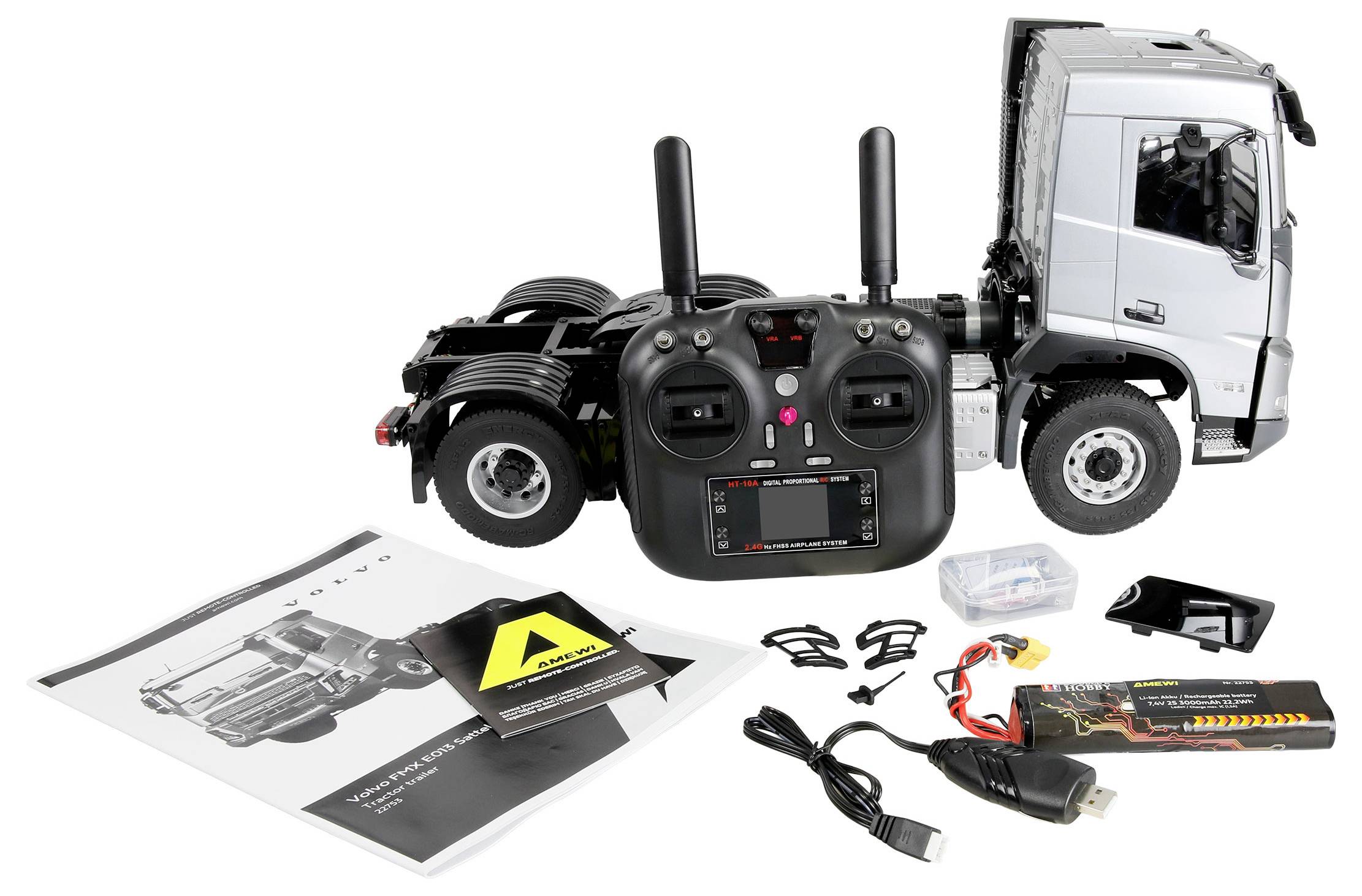 Remote-controlled truck model kit with controller, instruction manual, charger, and small assembly parts displayed on a white background