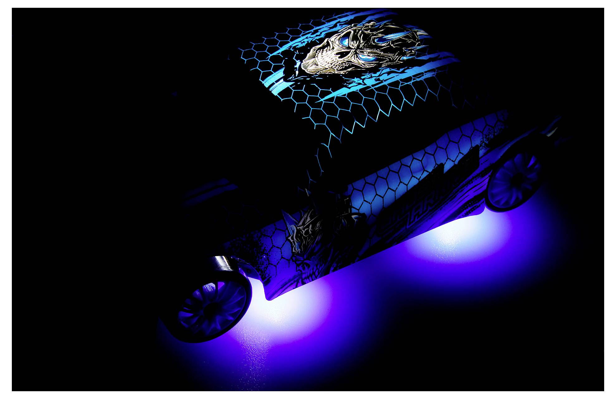 Futuristic blue car concept with glowing underlights and a dragon graphic on the body and roof against a black background.