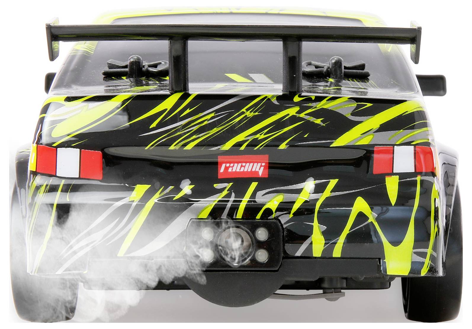 Front view of a black and neon yellow RC race car drifting, with smoke from the front wheels and a large rear spoiler.