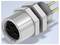 Close-up rendering of a circular metal electrical connector with threaded body, hex nut, black socket face, and two rear pins<br>
