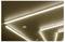 Ceiling with bright linear fluorescent lights arranged in diagonal and rectangular patterns.