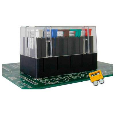 Close-up of a green circuit board with a black electrical relay module and a small yellow component beside it.