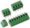 Assorted green screw terminal block connectors with metal pins, including two small, one large, and one detachable two-screw terminal.