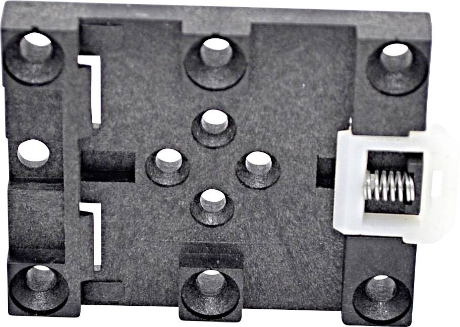 Close-up of a small black electronic switch or sensor module with mounting holes and a white spring-loaded connector on the right.