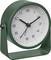 Green analog alarm clock with white face and black hands on a stand, showing about 10:10.
