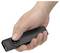 Hand holding a black electronic device or remote with a circular button, shown against a white background.