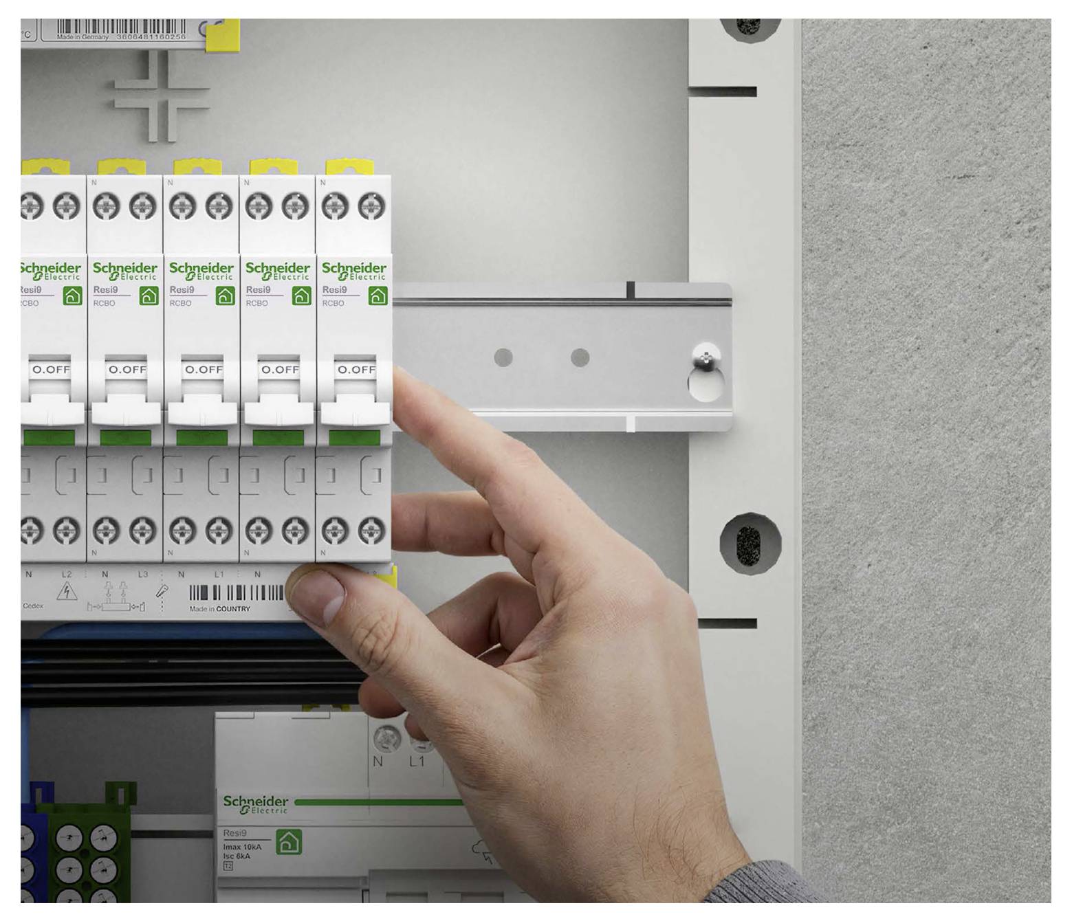 Hand adjusting a Schneider Electric circuit breaker inside an electrical panel.<br>