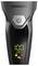 Close-up of a Carrera electric shaver showing a power button and digital display reading 100% battery with lock, plug, and cleaning icons.