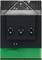 Close-up of a black and green electronic module with a vented top, three circular ports, and a small connector tab at the bottom.
