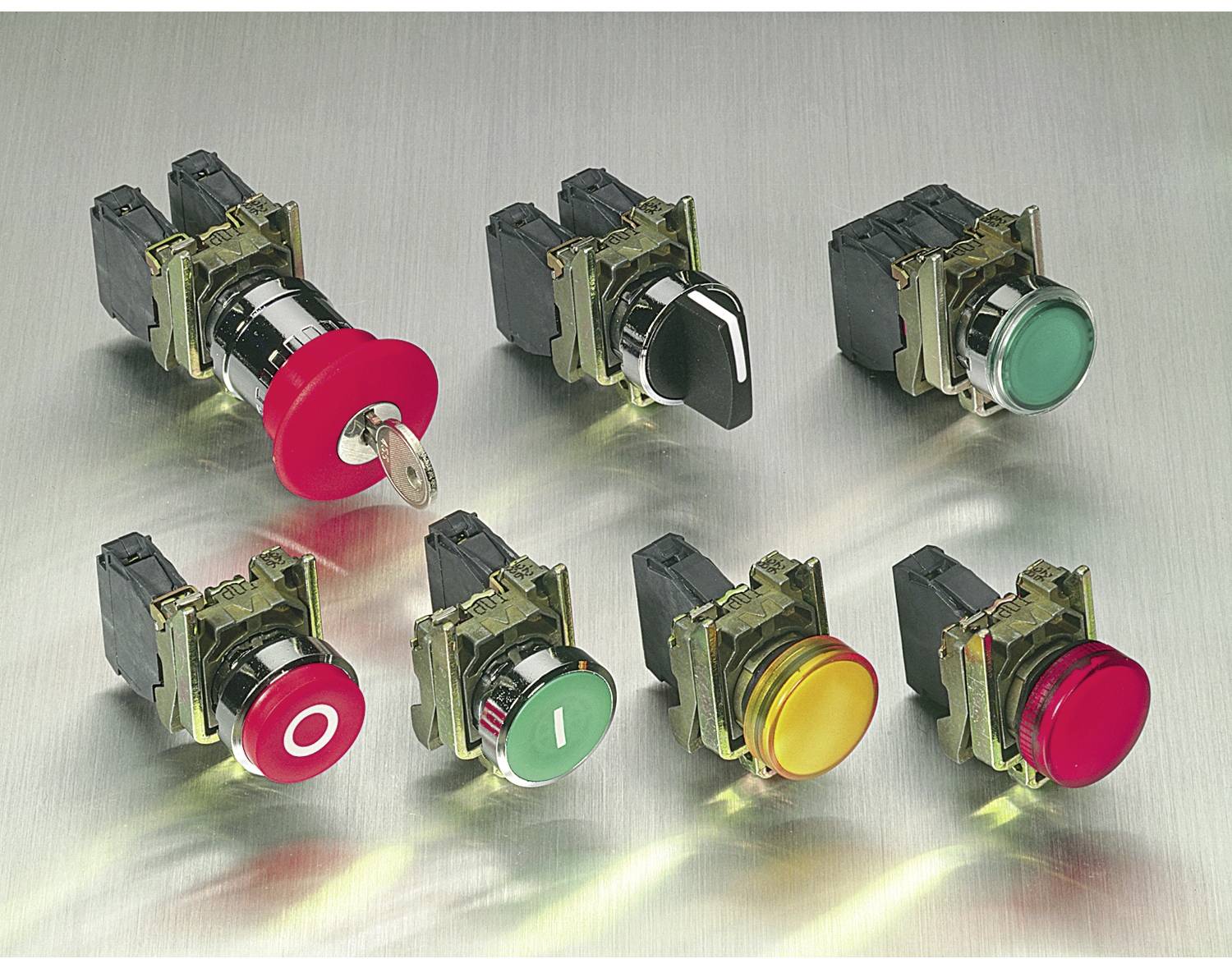 Seven industrial push-button switch assemblies with colored caps, including red key switch, black, green, yellow, and red buttons, shown on a metallic surface.