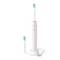 Pink electric toothbrush with charging base, USB cable, and two brush heads on a white background.