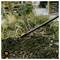 Garden hoe or cultivator tool lying on soil in a garden bed, with a '13 cm' measurement icon in the corner.