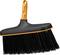 Black push broom with orange handle and trim, shown on a white background.<br>