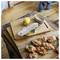 Wooden cutting boards with a lemon, grater, bowl, and prepared canapés on top, suggesting food preparation or serving.<br>
