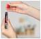 Hands holding a red marker cap above an uncapped black-and-red permanent marker, suggesting the cap is being removed or replaced.