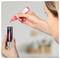 Hands apply red liquid marker to a black-and-white ECOline marker, showing refilling or coloring an ink cartridge.<br>