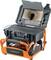 Portable sewer inspection camera system on a wheeled orange frame, with monitor showing a pipe interior and control keypad on the base.