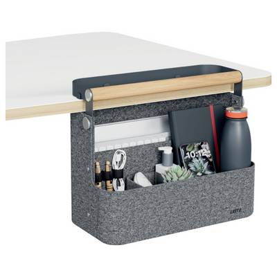 Hanging felt desk organizer with compartments holding pens, cables, notebook, plant, sanitizer, and water bottle on a tabletop.