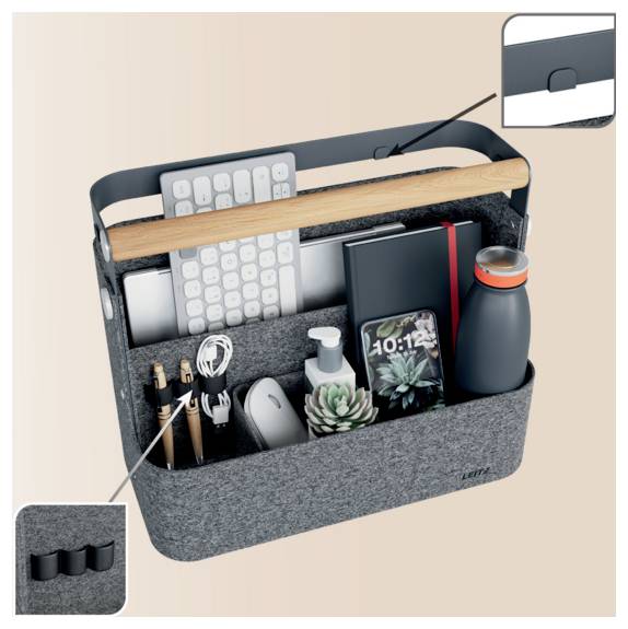 A gray felt desk caddy with a handle holds a keyboard, notebook, water bottle, pens, mouse, charger, phone, and other office items, with inset close-ups of the handle and side loops.