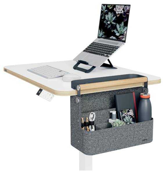Standing desk with laptop on an adjustable stand, keyboard, and under-desk storage organizer holding office supplies and a water bottle.