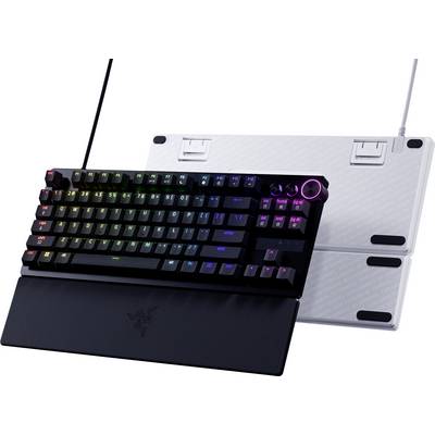 Mechanical gaming keyboard attached to a black laptop-style base, with rainbow backlit keys and a glowing pink control dial on a white stand behind it.