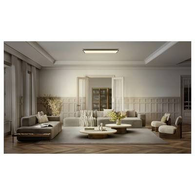 Elegant modern living room with sectional sofa, armchairs, coffee tables, rug, and wall molding in a soft neutral palette.