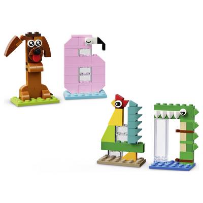 Four LEGO-style animal builds: a brown dog, pink flamingo, colorful bird, and green crocodile-like figure on a blue base.