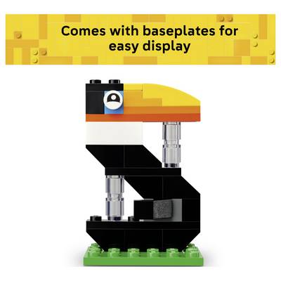 LEGO-style toucan model on a green baseplate with banner text 'Comes with baseplates for easy display'.