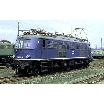 Blue electric locomotive marked '119 001-6' on railway tracks in a rail yard, with overhead power lines and other trains in the background.
