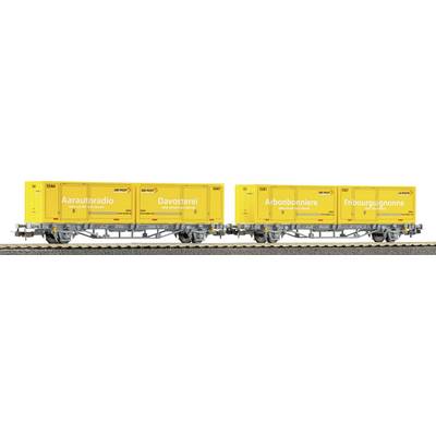 Yellow freight rail cars carrying container units labeled 'Arautoradi', 'Davosterei', 'Aibonbonniere', and 'Fribourgignon'.