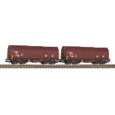 Two maroon freight rail containers on flatbed railcars, side by side on a track, shown in profile.