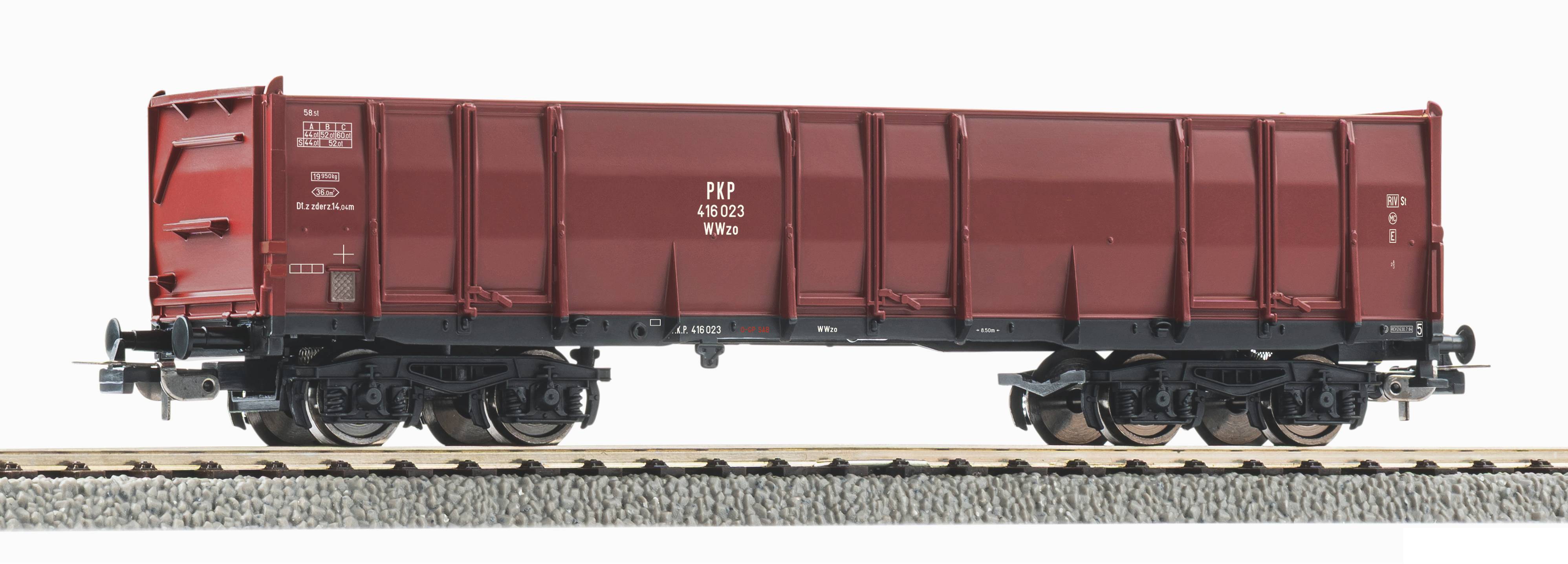 Side view of a red rail freight wagon on tracks against a white background.