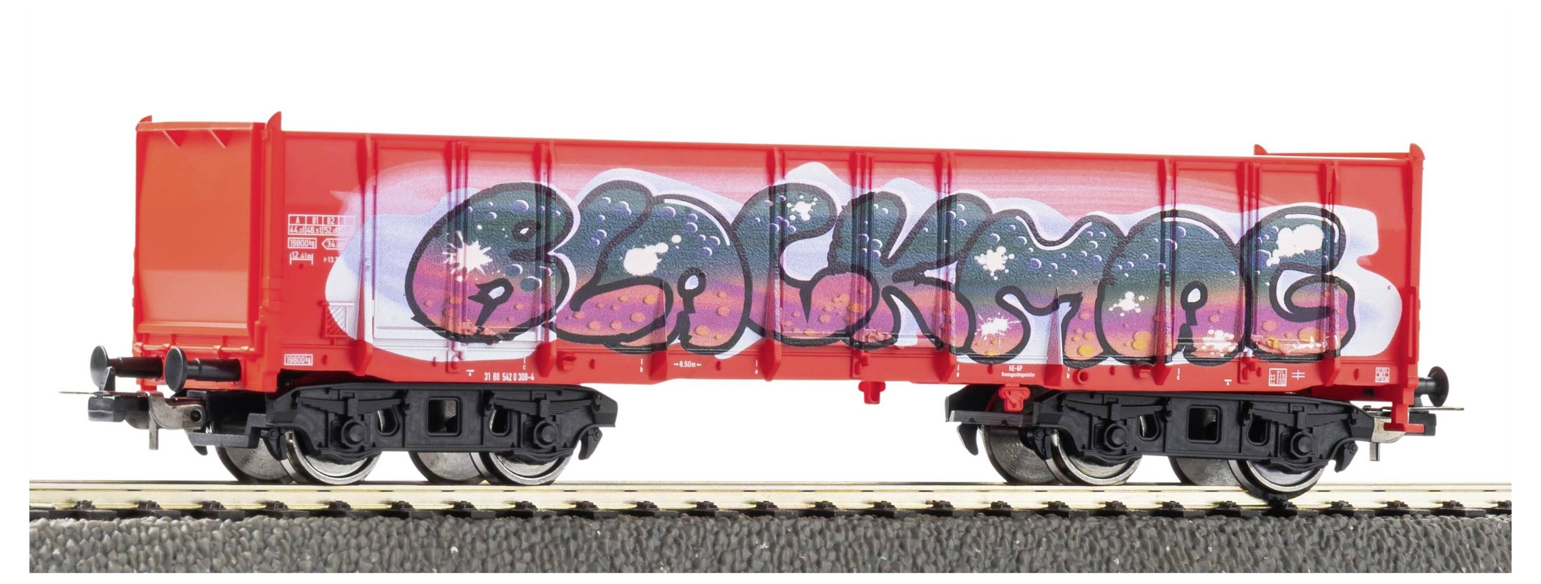 Red freight train car with large multicolored graffiti across the side, shown on tracks in profile.
