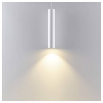 A modern silver pendant light on a gray wall casts a warm downward spotlight.