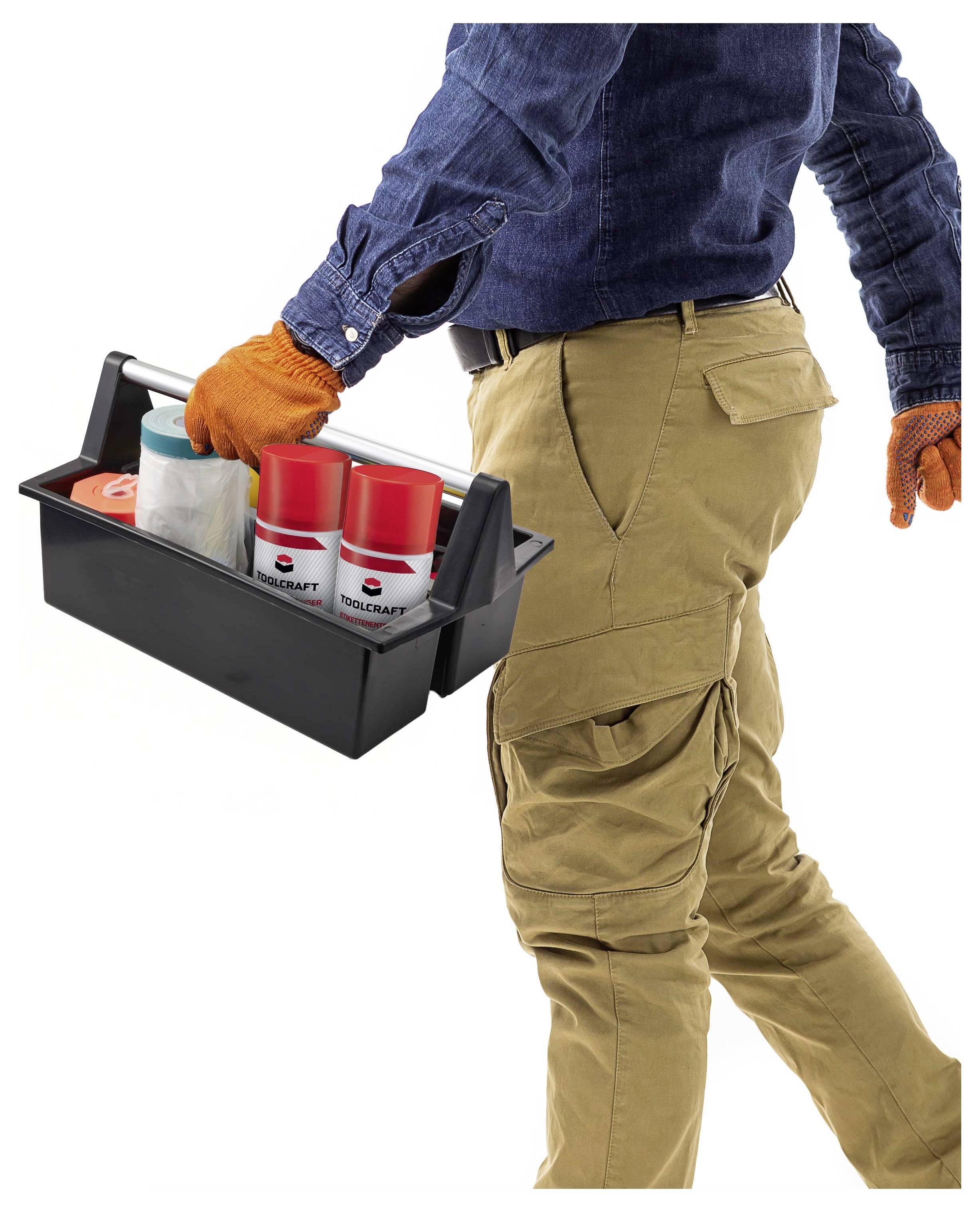 Worker in gloves carrying a toolbox with spray paint cans and supplies<br>
