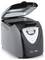 Countertop bread maker with lid open, showing the baking chamber and front control panel display/buttons.