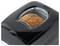 Black bread machine with a loaf of seeded bread baking inside a clear top window.